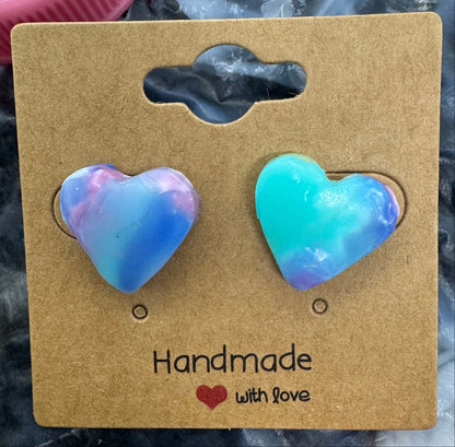 Heart-shaped earrings on a 'Handmade with Love' card against a marbled background.