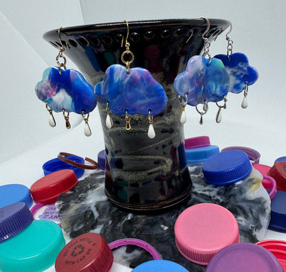 Colorful bottle caps on a stand with earrings displayed underneath