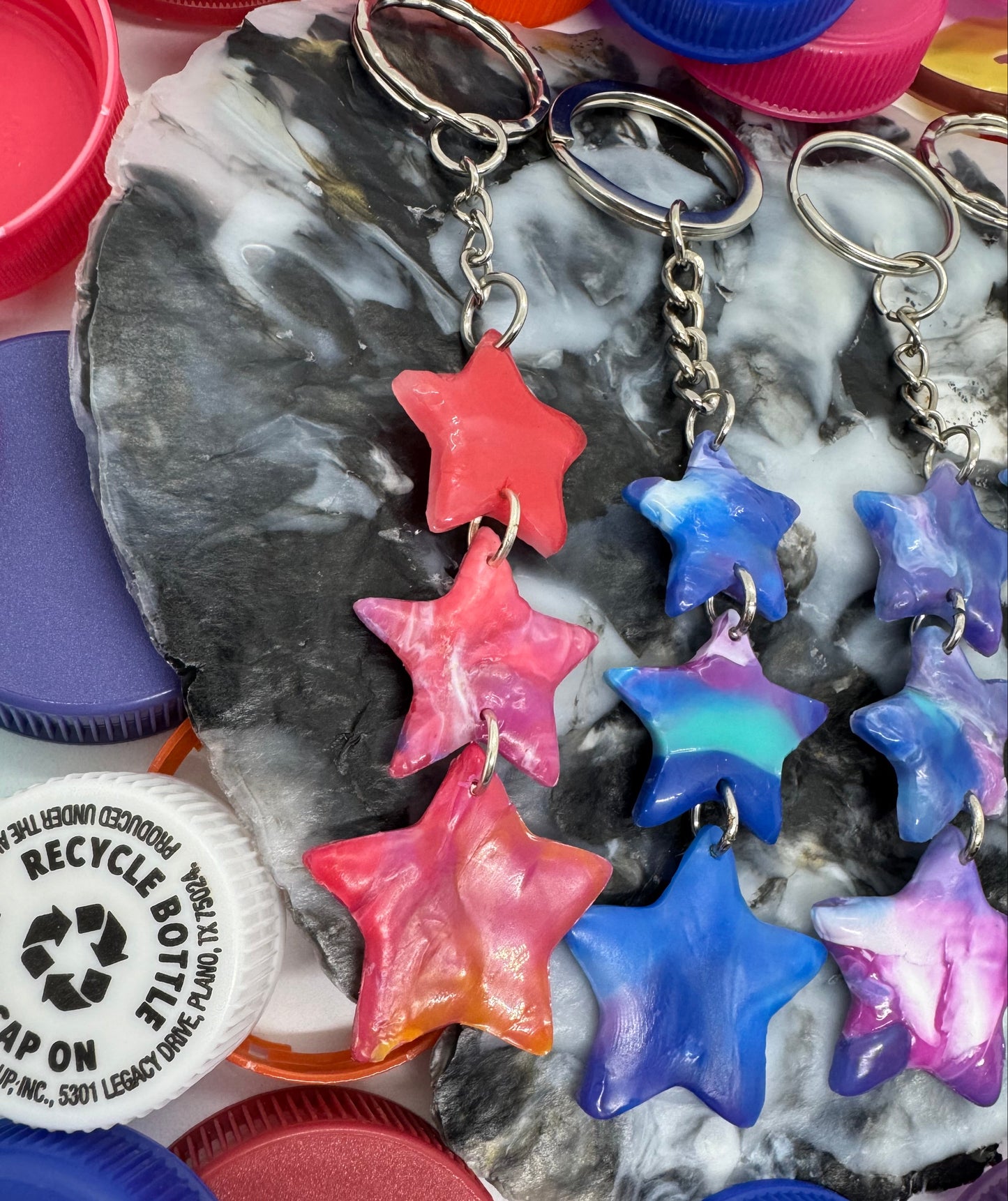 Colorful star-shaped objects on a textured surface with a recycling label visible.