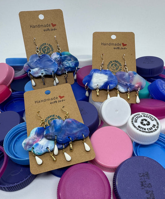 Colorful bottle caps with earrings on a white background