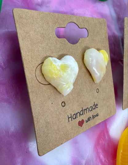 Heart-shaped earrings on a 'Handmade with Love' card against a pink and white background.