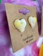 Heart-shaped earrings on a 'Handmade with Love' card against a pink and white background.