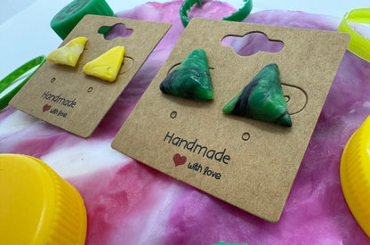 Green triangle earrings on a brown card with 'Handmade with Love' text, against a colorful background.