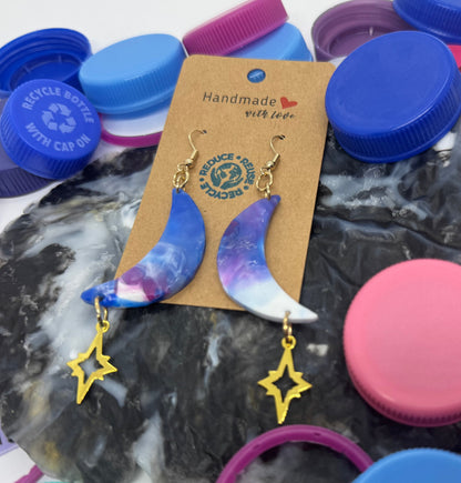 Colorful bottle caps with a pair of earrings on a stone surface