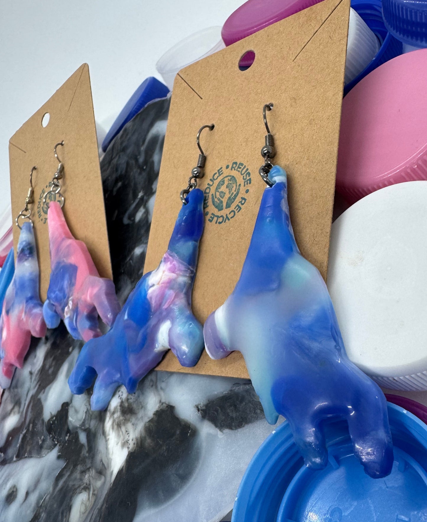 Colorful plastic bottle caps with a cardboard tag featuring a brand logo.