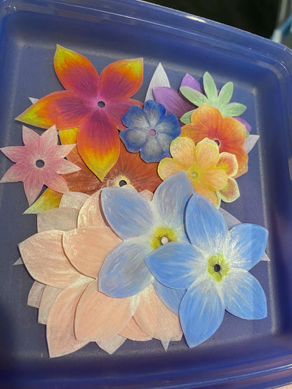 Colorful flower-shaped objects on a blue tray