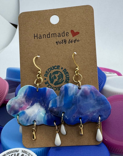 Colorful bottle caps with a pair of earrings on a tag, against a white background.