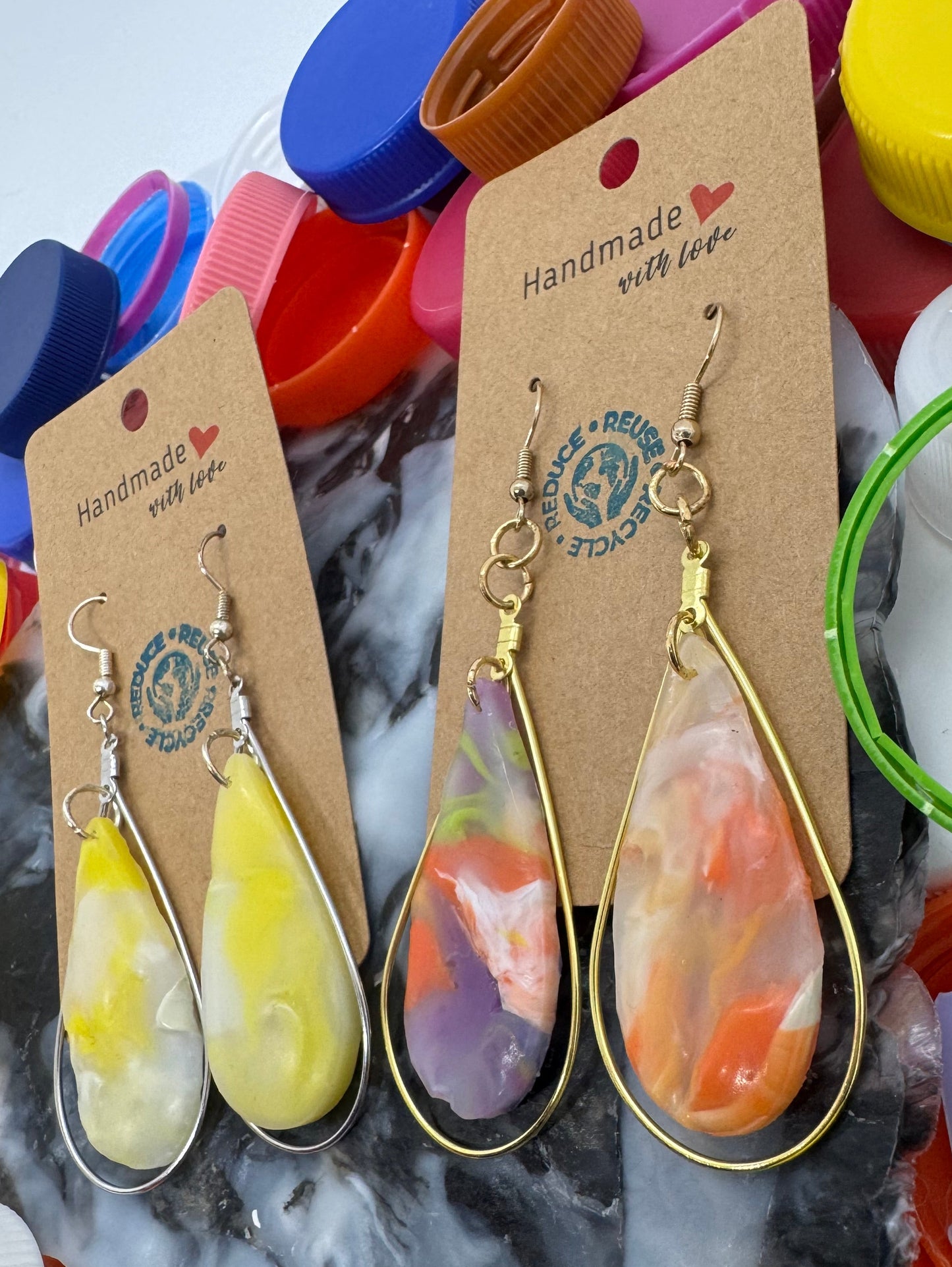 Colorful earrings on a card with a colorful background