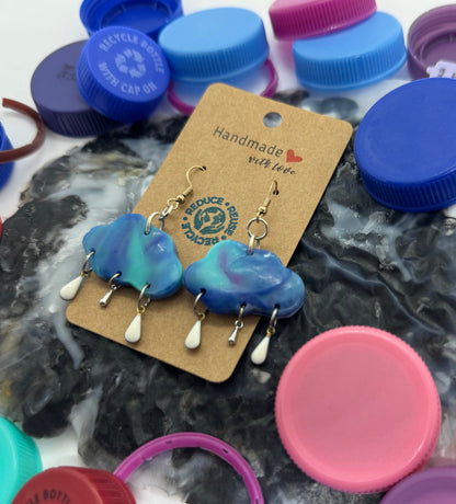 Jewelry set with a 'Handmade' tag surrounded by colorful bottle caps on a white background