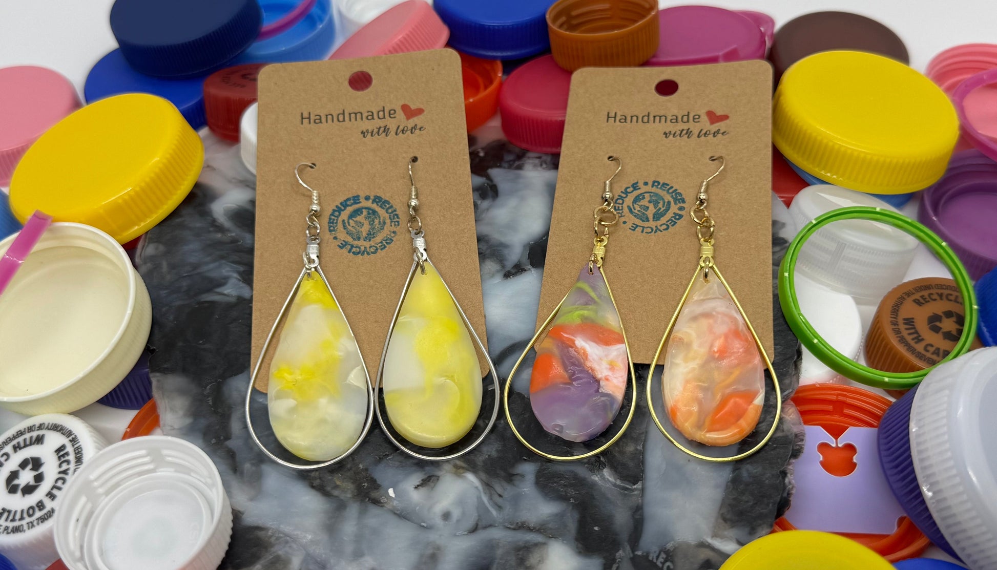 Colorful bottle caps with earrings on a white background