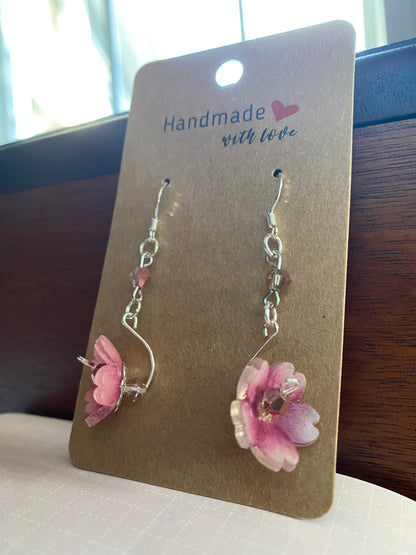 Flower-shaped earrings on a 'Handmade with Love' card.