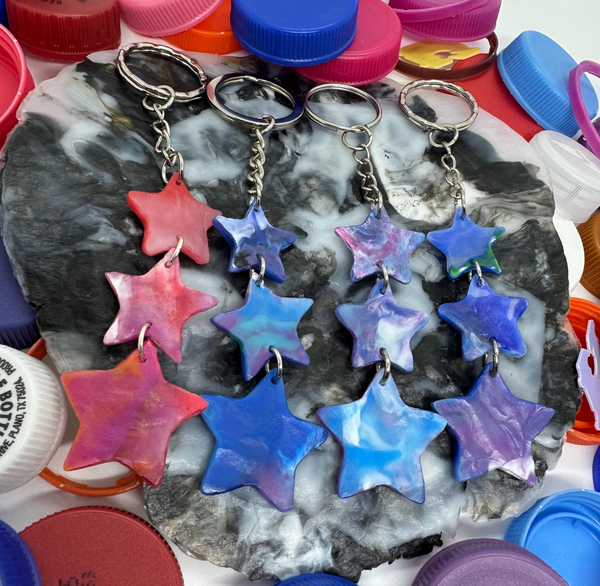 Colorful star-shaped objects and bottle caps on a white background