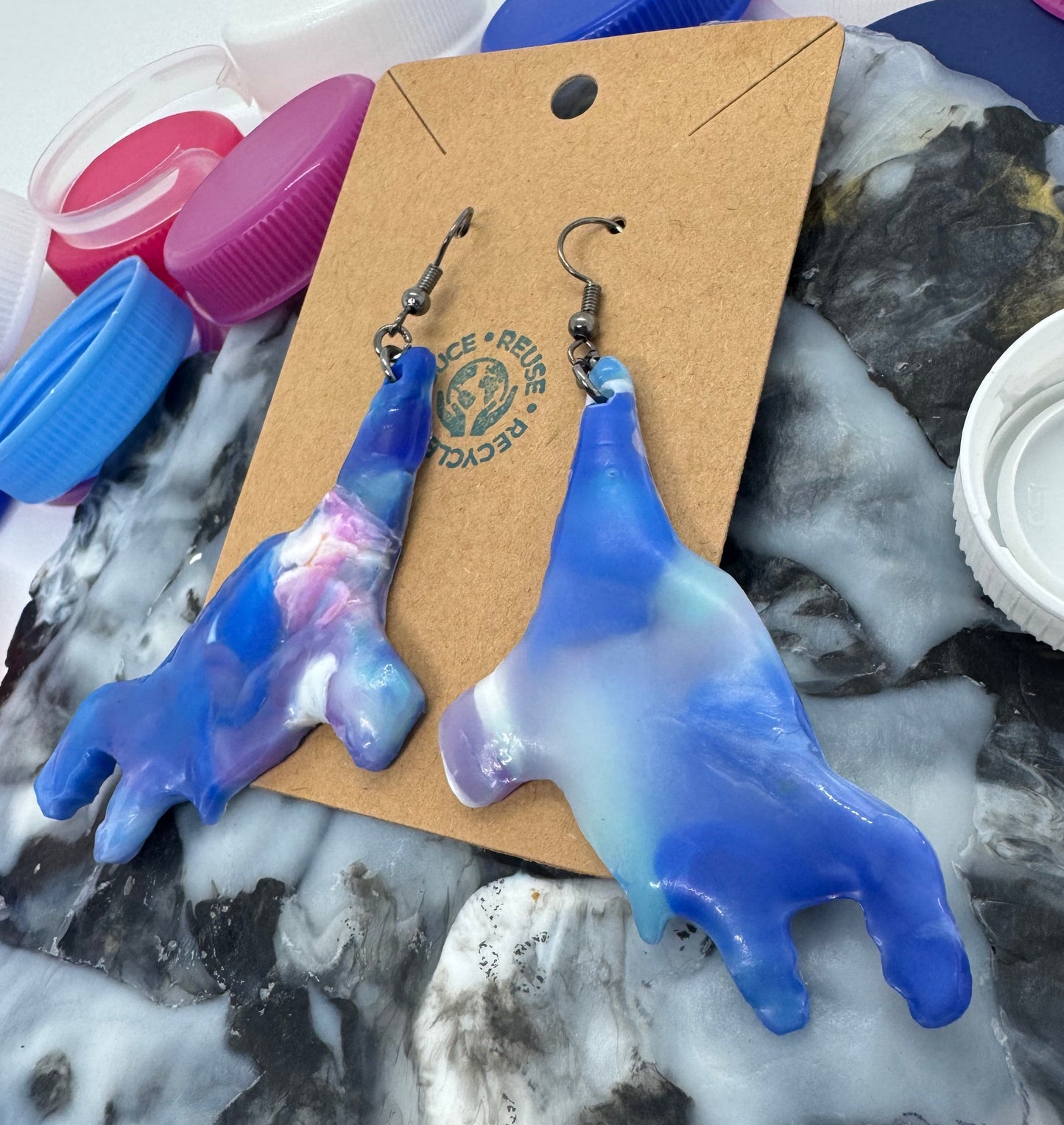 Blue and purple plastic tool on a marble surface with a brown card and keychain attached.