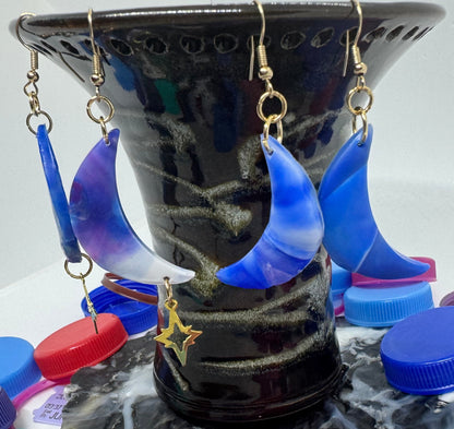 Black jewelry holder with colorful bottle caps on a white background