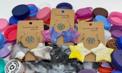 Colorful bottle caps and small jewelry items on a white background