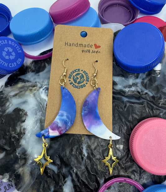 Earring set on a card with colorful bottle caps in the background